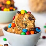 A bowl filled with cookies and m&m's.